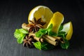 Spices; mint, star anise, cinnamon, lemon on a dark tree