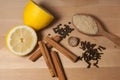Spices for mulled wine and lemon on a wooden board Royalty Free Stock Photo