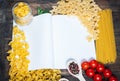 Spices, pasta and vegetables around notebook on a wooden table. Mockup