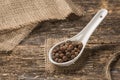 Spices in a spoon on old boards, cloth burlap Royalty Free Stock Photo