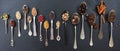 Variety of colorful spices in spoons on black stone background, top view, banner Royalty Free Stock Photo