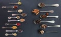 Variety of colorful spices in spoons on black stone background, top view Royalty Free Stock Photo