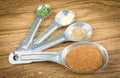 Spices In Spoons On Wooden Background