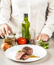 Spices, vegetables and a dish of fried medallion Royalty Free Stock Photo