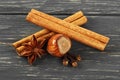 Spices on wooden background. Cinnamon, nuts, anise and cloves. Christmas background Royalty Free Stock Photo