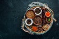 Spices in a wooden box. Colored pepper, sea salt, ground pepper, chili pepper.