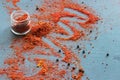 Spices in a wooden spoon. Various Indian spices on black stone table Royalty Free Stock Photo