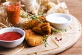 Spicy baked chicken wings with appetizers and sauces on round Royalty Free Stock Photo