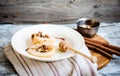 Spicy baked pear with walnuts, honey, cinnamon sticks, healthy d Royalty Free Stock Photo