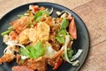 Spicy batter fried egg slice with chop chicken meat Thai salad on plate