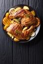 Spicy bbq chicken legs with grilled oranges, onions, garlic and