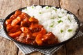 Spicy beef cooked with apples in tomato sauce with rice side dish close-up on a plate. horizontal Royalty Free Stock Photo