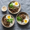 Spicy beef, rice and boiled egg bowl on grey background, top view. Asian food concept Royalty Free Stock Photo