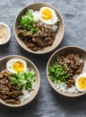 Spicy beef, rice and boiled egg bowl on grey background, top view. Asian food concept Royalty Free Stock Photo