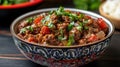 Spicy beef stew with tomatoes and herbs in decorative bowl Royalty Free Stock Photo