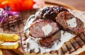 Spicy bifteki, frikadelle or frikkadel meatballs with minced beef and lamb with pita bread, tzatziki dip, vegetables salad and Fre Royalty Free Stock Photo