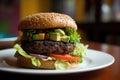 Spicy black bean burger, with patty made of black beans, and spices, topped with salsa, avocado and lettuce on a whole Royalty Free Stock Photo