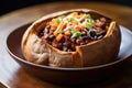 spicy black bean and sweet potato chili in a bread bowl