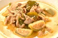 spicy boiled slice pork meat with eggplant in coconut milk green curry soup on plate