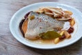 Spicy boiled Tilapia or mango fish tail with shimaji mushroon in tom yum soup on plate Royalty Free Stock Photo