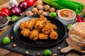 Spicy breaded chicken wings with homemade bread Royalty Free Stock Photo