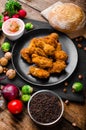 Spicy breaded chicken wings with homemade bread Royalty Free Stock Photo