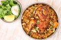 Spicy Bukhari Dajaj biryani with whole chicken and cashew nuts and salad served in dish isolated on table top view of arab food