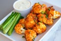 Spicy cauliflower buffalo bites served with ranch dip and celery sticks Royalty Free Stock Photo