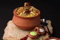 Spicy chicken biryani in traditional handi or clay pot.