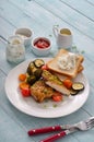 Spicy chicken breast on a white plate with grilled vegetables Royalty Free Stock Photo