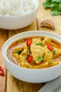 Spicy chicken breast in yellow curry sauce with garlic and chili  pepper with boiled rice in a bowl. Royalty Free Stock Photo