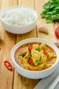 Spicy chicken breast in yellow curry sauce with garlic and chili  pepper with boiled rice in a bowl. Royalty Free Stock Photo