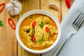 Spicy chicken breast in yellow curry sauce with garlic and chili  pepper with boiled rice in a bowl. Royalty Free Stock Photo