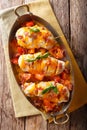 Spicy chicken fillet baked with bacon, tomatoes and cheddar cheese close-up in a pan. Vertical top view Royalty Free Stock Photo