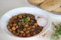 Spicy chickpea gravy with fried Indian flat bread. Locally known as Chole puri