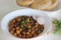 Spicy chickpea gravy with fried Indian flat bread. Locally known as Chole puri