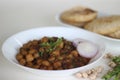 Spicy chickpea gravy with fried Indian flat bread. Locally known as Chole puri