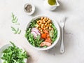 Spicy chickpeas, baked salmon, crispy radish, arugula salad on a light background, top view