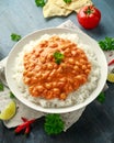 Spicy chickpeas curry with rice, tomato and Poppadoms in white plate. Healthy tasty vegetarian food