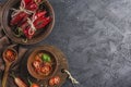Spicy chili on a dark background in ceramic plates, flatlay
