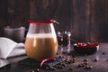 Spicy coffee latte with chili pepper in a glass on the table Royalty Free Stock Photo