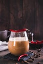 Spicy coffee latte with chili pepper in a glass on the table vertical view Royalty Free Stock Photo