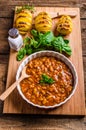 Spicy cowboy beans with hassleback potatoe with herbs Royalty Free Stock Photo