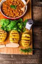 Spicy cowboy beans with hassleback potatoe with herbs Royalty Free Stock Photo