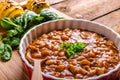 Spicy cowboy beans with hassleback potatoe with herbs Royalty Free Stock Photo