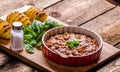 Spicy cowboy beans with hassleback potatoe with herbs Royalty Free Stock Photo