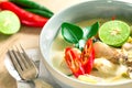 Spicy creamy coconut soup with chicken , Thai food called Tom Kha Gai on the wooden table Royalty Free Stock Photo