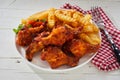 Spicy crumbed chicken wings with French Fries Royalty Free Stock Photo