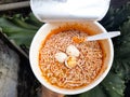 Spicy cup instant noodles with additional boiled quail eggs toppings Royalty Free Stock Photo