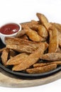 Spicy curry powder coated crispy deep fried potato wedges